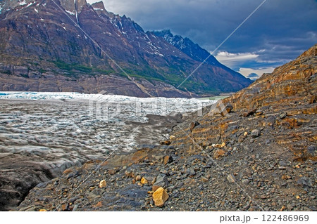 Surface of Grey Glacier with crevasses and surrounding dramatic mountains in Torres del Paine National Park Surface of Grey Glacier with crevasses and surrounding dramatic mountains in Torres del Paine National Park 122486969