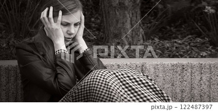 Sad girl in the park 122487397