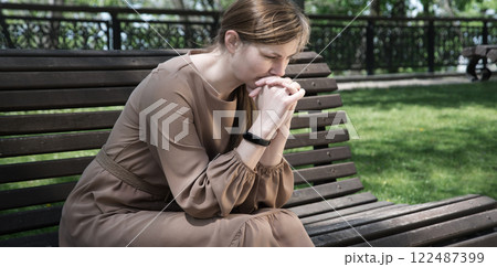 Pretty girl sitting on the bench 122487399