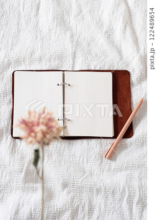Open journal on the blanket. Open journal on the blanket. 122489654