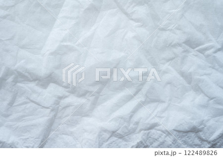 Full frame shot of crumpled tissue fabric texture and background. Tissue fabric is slightly rough and crisp in texture. 122489826