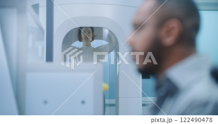 Airport Security Checkpoint: Close Up Security Officer Monitors Passenger Screening Airport Security Checkpoint: Close Up Security Officer Monitors Passenger Screening 122490478
