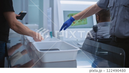 Airport Security Checkpoint: Diverse People Put Personal Items in Plastic Trays for Screening 122490480