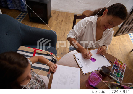 Mother and Daughter Enjoy Creative Painting Activity at Cozy Home Table Mother and Daughter Enjoy Creative Painting Activity at Cozy Home Table 122491914