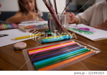 Children Engaged in Arts and Crafts With Colorful Supplies and Pencils Children Engaged in Arts and Crafts With Colorful Supplies and Pencils 122491923
