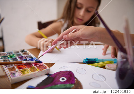 Children painting and drawing with watercolors and creativity supplies 122491936
