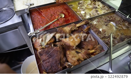 A Gastronomic Array of Roasted Lamb, Stews, and Vibrant Sauces in a A Gastronomic Array of Roasted Lamb, Stews, and Vibrant Sauces in a 122492879