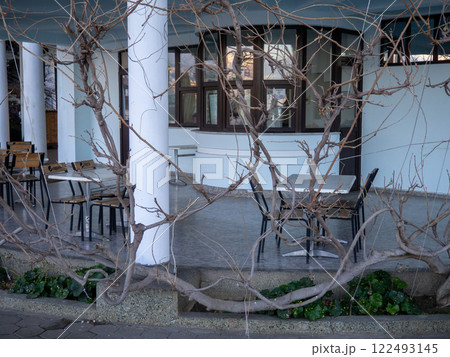 Restaurant veranda in winter. Empty tables in a cafe. Winter at the summer resort. Business under threat 122493145