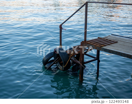 Old pier. Place of entry into the water. Tires on the pier. 122493148