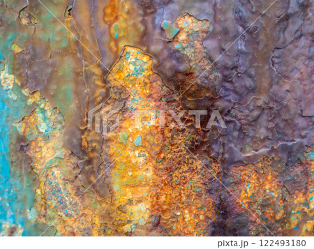 Rust on a blue surface. Cracks in the paint. Old iron. Rusty metal. 122493180