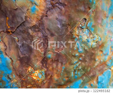 Rust on a blue surface. Cracks in the paint. Old iron. Rusty metal. 122493182
