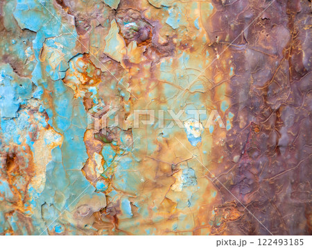 Rust on a blue surface. Cracks in the paint. Old iron. Rusty stains on metal. 122493185