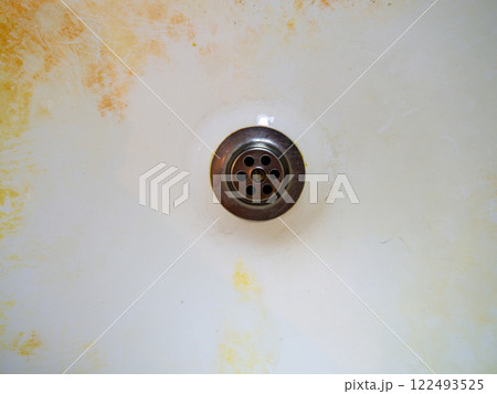 Mold on bathroom enamel. Black dots of mold and yellow plaque. Requires cleaning. Before using cleaning products. Mold on bathroom enamel. Black dots of mold and yellow plaque. Requires cleaning. Before using cleaning products. 122493525