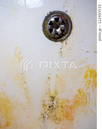 Mold on bathroom enamel. Black dots of mold and yellow plaque. Requires cleaning. Before using cleaning products. Mold on bathroom enamel. Black dots of mold and yellow plaque. Requires cleaning. Before using cleaning products. 122493533