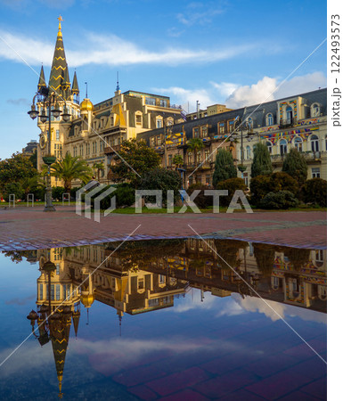 Landmark of Batumi in the reflection of a puddle. Europe Square. Architecture of Georgia. City Park. 122493573