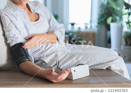 Women's hands measure their own blood pressure with a tonometer. Concept hypotension, hypertension. 122493763