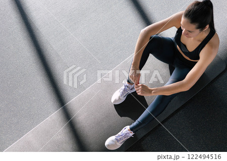 Athletic fitness woman stretching body at gym enjoy physical exercise activity. 122494516