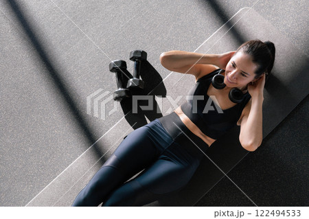 Beautiful athletic Asian woman trains in gymnastics studio, enjoys flexibility, healthy lifestyle Beautiful athletic Asian woman trains in gymnastics studio, enjoys flexibility, healthy lifestyle 122494533