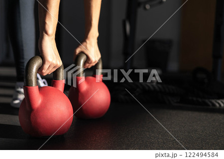 Athletic bodybuilding sport woman squat with kettlebell fitness training at gym. Athletic bodybuilding sport woman squat with kettlebell fitness training at gym. 122494584