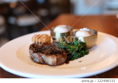 medium rare steak Freshly grilled pieces of beef steak meat on a fork rotating. Close-up of food 122496132