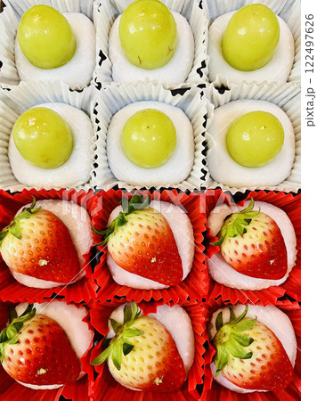 Mochi or daifuku with toppiong strawberry and grape inside with red bean and green tea, Japanese dessert 122497626