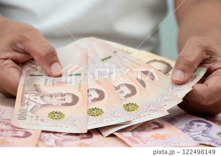 Asian woman counting Thai baht banknote money, investment economy, accounting business and banking. 122498149