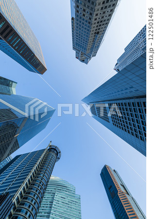 Low-angle building view of the modern office skyscrapers in the financial district of Raffles Place, Singapore. Low-angle building view of the modern office skyscrapers in the financial district of Raffles Place, Singapore. 122501486