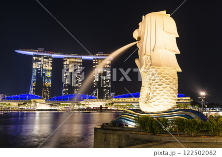 Low-angle view of the Merlion with the background of Marina Bay Sands buildings in Singapore. Merlion is the official mascot of Singapore. Low-angle view of the Merlion with the background of Marina Bay Sands buildings in Singapore. Merlion is the official mascot of Singapore. 122502082