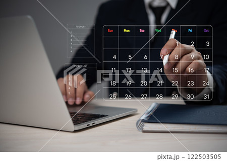 Businessman holding pen marks on virtual screen calendar, business marketing Planning Calendar Agenda work schedule, time management Workflow to do list 122503505