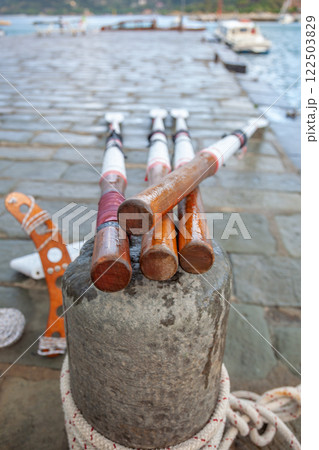 Wooden Oars on an Old Stone Pier Wooden Oars on an Old Stone Pier 122503829
