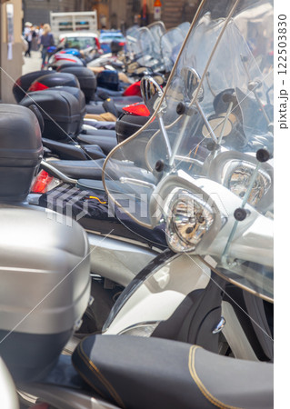 Several Motorbikes Parked on a Sunny Summer Street Several Motorbikes Parked on a Sunny Summer Street 122503830
