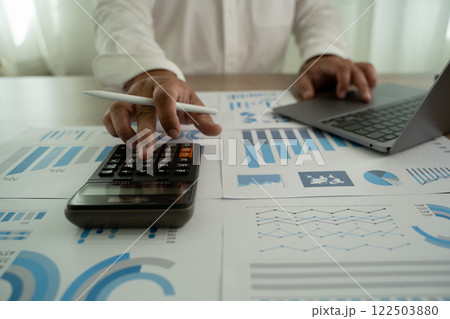 man is using a calculator budgeting and tax calculation budget management 122503880