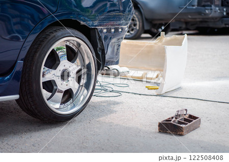 Checking car body work fiber bumper at car garage Checking car body work fiber bumper at car garage 122508408