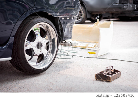 Checking car body work fiber bumper at car garage 122508410