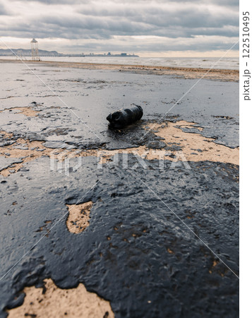 Oil on Black sea coastline after a tanker wreck. The beach is polluted with fuel oil 122510495