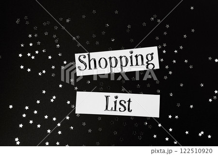 Shopping list is written on a piece of paper with stars scattered around it 122510920