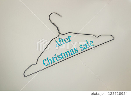 Christmas sale sign is hanging on a clothes hanger 122510924