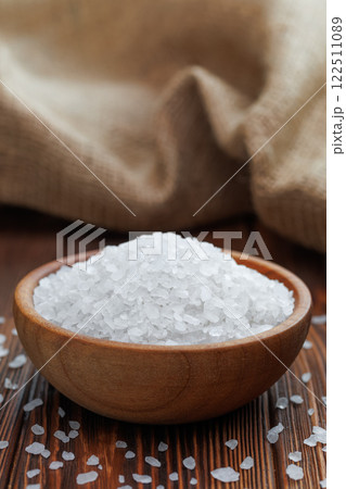 sea salt in wooden bowl on table with burlap on the background 122511089