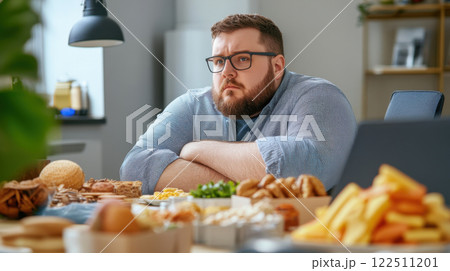 Overweight Man Practicing Mindful Eating at Work 122511201