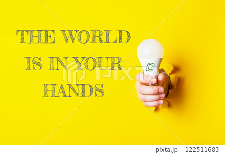 Person holding a light bulb with the words The world is in your hands Person holding a light bulb with the words The world is in your hands 122511683