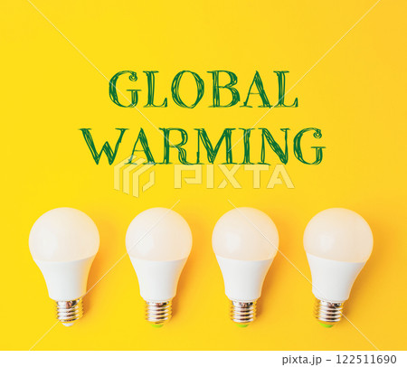 A group of four light bulbs on a yellow background with the words Global Warming A group of four light bulbs on a yellow background with the words Global Warming 122511690