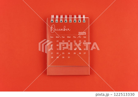 December 2025 red color desk calendar on red background. December 2025 red color desk calendar on red background. 122513330