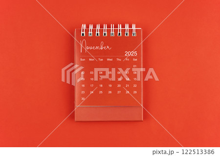 November 2025 red color desk calendar on red background. November 2025 red color desk calendar on red background. 122513386