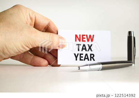 New tax year symbol. Concept words New tax year on beautiful white card. Beautiful white background. Businessman hand. Business new tax year concept. Copy space. 122514392
