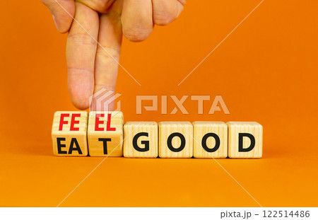 Eat and feel good symbol. Concept words Eat good Feel good on wooden cubes. Beautiful orange table orange background. Doctor hand. Healthy lifestyle eat and feel good concept. Copy space. Eat and feel good symbol. Concept words Eat good Feel good on wooden cubes. Beautiful orange table orange background. Doctor hand. Healthy lifestyle eat and feel good concept. Copy space. 122514486