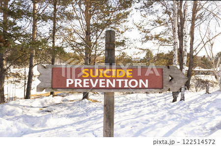 Suicide prevention symbol. Concept words Suicide prevention on beautiful wooden road sign. Beautiful snow forest background. Psychological and suicide prevention concept. Copy space. Suicide prevention symbol. Concept words Suicide prevention on beautiful wooden road sign. Beautiful snow forest background. Psychological and suicide prevention concept. Copy space. 122514572