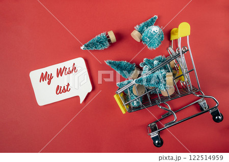Shopping cart full of Christmas trees with a sign that says My Wish List Shopping cart full of Christmas trees with a sign that says My Wish List 122514959