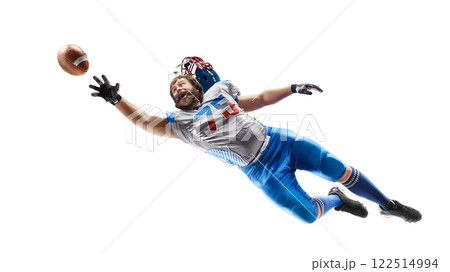 American football player catches the ball in the air. Sport emotion. Falls and tries to reach the ball. Sportsman in action. American football. Isolated 122514994