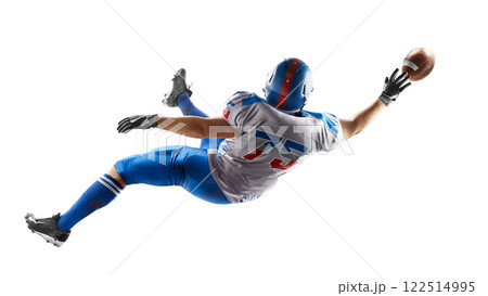 American football player catches the ball in the air. Falls and tries to reach the ball. Sportsman in action. Back view. American football. Isolated 122514995