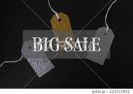 Three tags with gold and silver glitter are hanging Three tags with gold and silver glitter are hanging 122515601